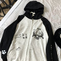 Hoodie with black and white design on a checkered surface